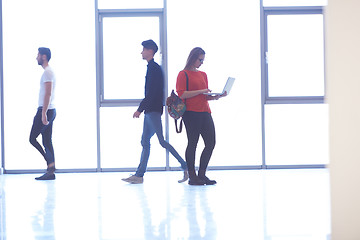 Image showing student girl standing with laptop, people group passing by