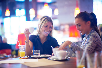 Image showing girls have cup of coffee in restaurant