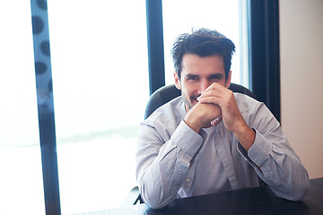 Image showing relaxed young man drink first morning coffee withh rain drops on