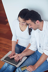 Image showing relaxed young couple working on laptop computer at home