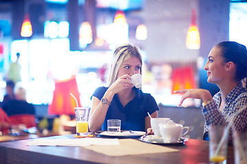 Image showing girls have cup of coffee in restaurant