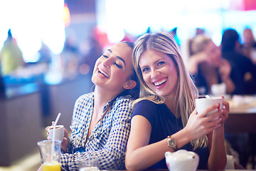 Image showing girls have cup of coffee in restaurant