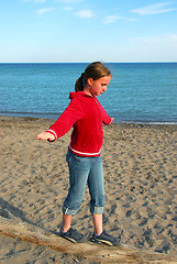 Image showing Girl balancing on log