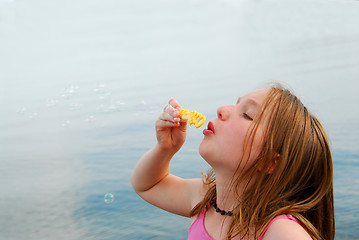 Image showing Girl blowing bubbles