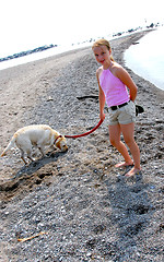 Image showing Girl walking dog