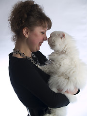 Image showing Young Lady touching cat nose to nose