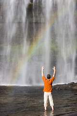 Image showing Man and waterfall with rainbow