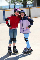 Image showing Two girls rollerblading