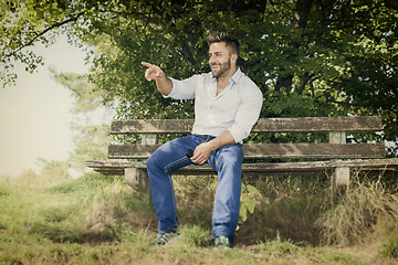 Image showing man outdoors pointing