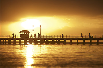 Image showing Sunset setting over pier