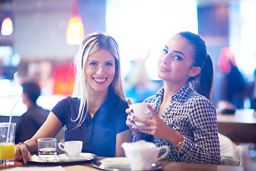 Image showing girls have cup of coffee in restaurant