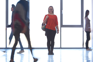 Image showing student girl standing with laptop, people group passing by