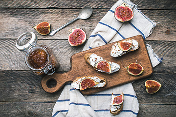 Image showing rustic style food snaks with jam and figs on napkin