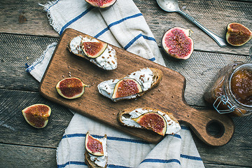 Image showing rustic style healthy snacks with cut figs on napkin