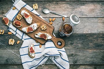 Image showing snacks with cheese jam and figs on wood