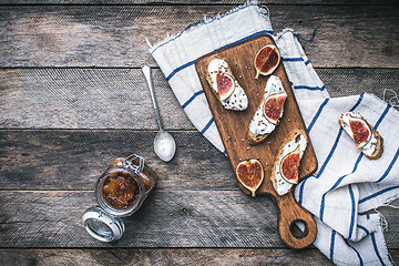 Image showing Healthy snacks with cheese and figs on wood board