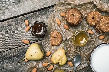 Image showing Pears nuts Cookies and milk on rustic wood