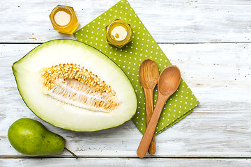 Image showing green pear Healthy melon and honey on rustic wood