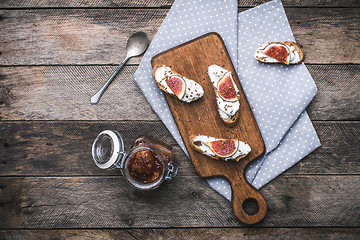 Image showing rustic style tasty Bruschetta snacks with jam and figs