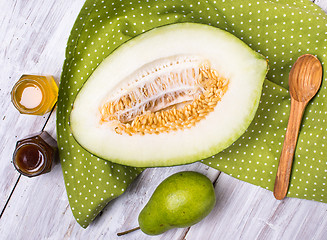 Image showing Tasty melon with honey and pears on napkin