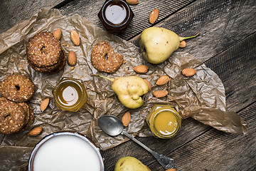 Image showing Healthy Pears almonds Cookies and milk on rustic wood