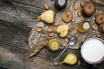 Image showing Pears Cookies Almonds and milk on wood