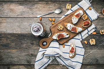 Image showing Bruschetta snacks with nuts jam and figs on napkin