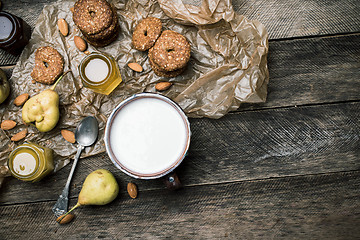 Image showing  ears Cookies Almonds and milk on wood