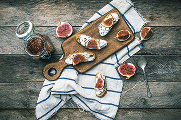Image showing rustic style Bruschetta with cheese and figs on napkin