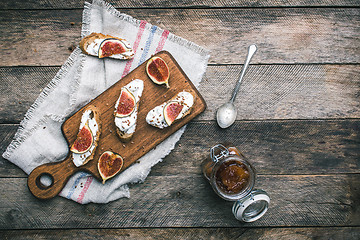 Image showing Bruschetta snacks with jam and figs on napkin