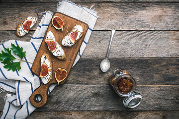 Image showing Bruschetta snacks with jam and figs rustic style