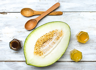 Image showing Healthy melon with honey on rustic board