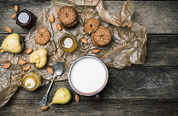 Image showing Tasty Pears almonds Cookies and joghurt on rustic wood