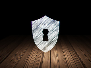 Image showing Security concept: Shield With Keyhole in grunge dark room