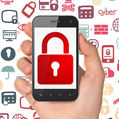 Image showing Safety concept: Hand Holding Smartphone with Closed Padlock on display