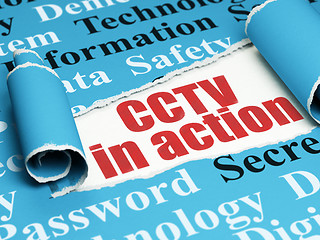 Image showing Safety concept: red text CCTV In action under the piece of  torn paper