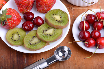 Image showing fruit with cherry, strawberry, kiwi on wooden plate