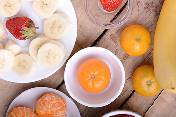 Image showing Fresh colorful fruits composition mandarin, strawberry, peach, bananas and orange