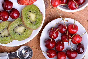 Image showing fruit with cherry, strawberry, kiwi on wooden plate