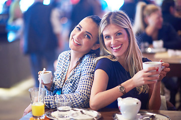 Image showing girls have cup of coffee in restaurant