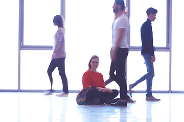 Image showing student girl standing with laptop, people group passing by