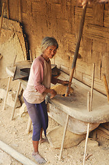 Image showing Old woman grinding grain in Nagaland, India