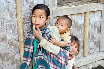 Image showing Older sister carrying kids in Nagaland, India