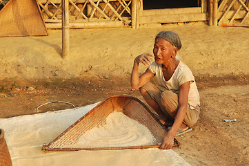 Image showing Old woman sifting flour in Nagaland, India