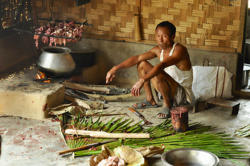 Image showing Man cooking meat in Nagaland, India