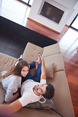 Image showing young couple watching tv at home