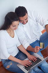 Image showing relaxed young couple working on laptop computer at home