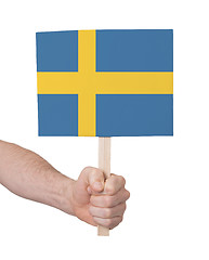 Image showing Hand holding small card - Flag of Sweden