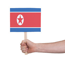 Image showing Hand holding small card - Flag of North Korea