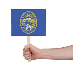 Image showing Hand holding small card - Flag of Nebraska